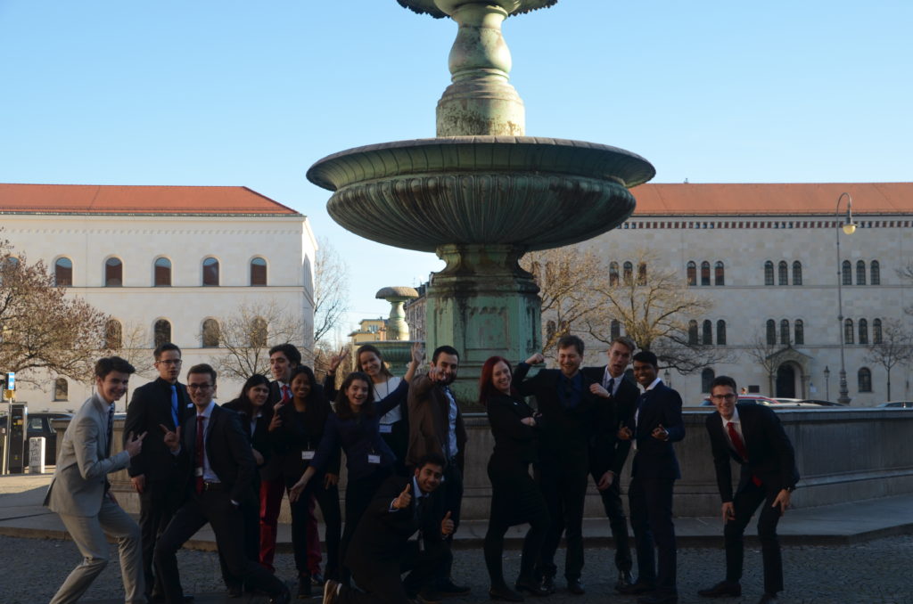 UN Legal dancing the stress away in front of beautiful LMU building